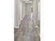 Spacious hallway featuring sleek hardwood floors, providing a seamless transition throughout the living space at 18415 Depoe Ln, Westfield, IN 46074