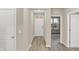 Bright hallway with sleek floors that leads to the front door, offering a welcoming entrance to the home at 18415 Depoe Ln, Westfield, IN 46074