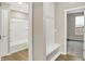 Hallway featuring hooks, built in bench, and an adjacent bathroom that provides practicality and convenience for residents at 18415 Depoe Ln, Westfield, IN 46074