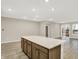 Bright, open-concept kitchen with a large island, hardwood floors, and modern recessed lighting at 18415 Depoe Ln, Westfield, IN 46074