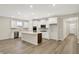 Modern kitchen with white cabinets, stainless steel appliances, and an island with seating at 18415 Depoe Ln, Westfield, IN 46074