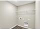 Efficient laundry room with ample space for laundry machines and storage at 18415 Depoe Ln, Westfield, IN 46074