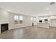Spacious living room with a cozy fireplace and an open view to the modern kitchen at 18415 Depoe Ln, Westfield, IN 46074
