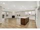 Open-concept living room featuring a fireplace and access to a kitchen with an island at 18415 Depoe Ln, Westfield, IN 46074