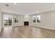 Inviting living room features a cozy fireplace, hardwood floors, and large windows at 18415 Depoe Ln, Westfield, IN 46074