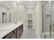 Bathroom features a long vanity with double sinks and a glass-enclosed shower at 18415 Depoe Ln, Westfield, IN 46074