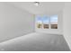 Spacious bedroom with carpet and natural light from three large windows at 251 Hunters Ridge Dr, Danville, IN 46122