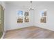 Cozy dining room featuring wood floors, large windows, and a modern chandelier at 251 Hunters Ridge Dr, Danville, IN 46122