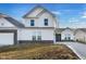 New construction home featuring a white exterior, dark brick foundation, and manicured yard at 251 Hunters Ridge Dr, Danville, IN 46122