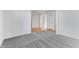 Hallway with carpet, leading to rooms with wood floors and white trim at 251 Hunters Ridge Dr, Danville, IN 46122