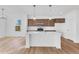 Modern kitchen with a center island, stainless appliances, white countertops, and luxury vinyl floors at 251 Hunters Ridge Dr, Danville, IN 46122