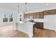 Kitchen with an island, stainless appliances, modern lighting, and luxury vinyl floors at 251 Hunters Ridge Dr, Danville, IN 46122