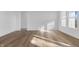 Open-concept living room with luxury vinyl plank flooring, white walls, and natural light at 251 Hunters Ridge Dr, Danville, IN 46122
