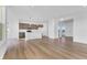 Spacious open-concept living area with luxury vinyl floors, white walls, and stainless appliances at 251 Hunters Ridge Dr, Danville, IN 46122