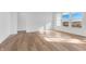 Bright living room with luxury vinyl floors, white walls and a large window at 251 Hunters Ridge Dr, Danville, IN 46122