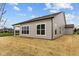 View of the back exterior showing large windows and vinyl siding at 5005 Carmine St, Brownsburg, IN 46112