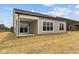 Back exterior view featuring covered porch, sliding glass door, and vinyl siding at 5005 Carmine St, Brownsburg, IN 46112