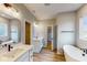 Modern bathroom with double vanity, soaking tub, and walk-in shower at 5005 Carmine St, Brownsburg, IN 46112