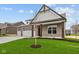 Beautiful gray brick home with covered porch and manicured lawn at 5005 Carmine St, Brownsburg, IN 46112