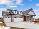 Brick house with three-car garage, dormer windows and gray roof at 5005 Carmine St, Brownsburg, IN 46112