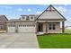 Charming brick home with a spacious three car garage and well-manicured lawn at 5005 Carmine St, Brownsburg, IN 46112