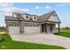 Stunning brick home with a three-car garage and a long driveway at 5005 Carmine St, Brownsburg, IN 46112