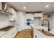 Modern kitchen with white cabinets, stainless steel appliances, and a large island at 5005 Carmine St, Brownsburg, IN 46112