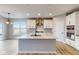 Modern kitchen with white cabinets, stainless steel appliances and large island at 5005 Carmine St, Brownsburg, IN 46112