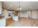 Open concept kitchen with island, stainless steel appliances, and light-colored cabinets at 5005 Carmine St, Brownsburg, IN 46112