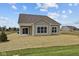Spacious backyard featuring a covered patio, perfect for outdoor entertaining and relaxation at 5021 Carmine St, Brownsburg, IN 46112