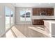 Bright eat-in kitchen with hardwood floors, sliding glass door, and ample sunlight at 5021 Carmine St, Brownsburg, IN 46112