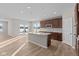 Modern kitchen with island, stainless steel appliances, and hardwood floors at 5021 Carmine St, Brownsburg, IN 46112