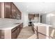 Modern kitchen with island, stainless steel appliances, and hardwood floors at 5021 Carmine St, Brownsburg, IN 46112