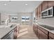 Open concept kitchen with island, stainless steel appliances, and view to backyard at 5021 Carmine St, Brownsburg, IN 46112