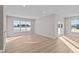 Sunlit living room with hardwood floors and sliding glass doors at 5021 Carmine St, Brownsburg, IN 46112