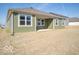 The backyard features a covered patio with multiple windows and a large open space at 245 Lar Lan Dr, Danville, IN 46122