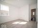Spacious carpeted bedroom with a window, white walls, and closet space at 245 Lar Lan Dr, Danville, IN 46122