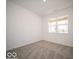Bright, carpeted bedroom with large window allowing natural light and a view of the neighborhood at 245 Lar Lan Dr, Danville, IN 46122