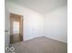 A bright, airy bedroom, features neutral carpet, and white walls at 245 Lar Lan Dr, Danville, IN 46122