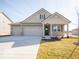Charming single-Gathering home boasting a two-car garage, neutral siding, and a well-manicured lawn at 245 Lar Lan Dr, Danville, IN 46122