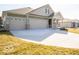 An inviting exterior view of a home with a spacious driveway and three-car garage, nestled in a peaceful neighborhood at 245 Lar Lan Dr, Danville, IN 46122