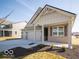A well-maintained single-Gathering home featuring a covered porch, three-car garage and landscaped front yard at 245 Lar Lan Dr, Danville, IN 46122