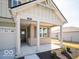 Welcoming front porch with classic columns and a cozy entryway, nestled within a friendly community at 245 Lar Lan Dr, Danville, IN 46122
