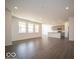 Bright and open living space with hardwood floors seamlessly connects to the modern kitchen for easy living at 245 Lar Lan Dr, Danville, IN 46122