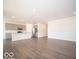 Open-concept living area features hardwood floors, flowing into a modern kitchen with stainless steel appliances at 245 Lar Lan Dr, Danville, IN 46122