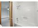 Clean, white bathroom with a shower and tub combo, and a view into the bedroom at 521 Eagle Crest Dr, Brownsburg, IN 46112