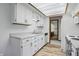 Well-lit kitchen features white cabinets, laminate countertops, and stainless steel appliances at 521 Eagle Crest Dr, Brownsburg, IN 46112