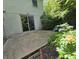 A back patio features a sliding glass door and is surrounded by lush greenery at 6605 Donnelly Dr, Brownsburg, IN 46112