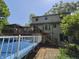 Two-story home's backyard features a pool, patio area, screened-in porch, and stairs leading to walkout basement at 6605 Donnelly Dr, Brownsburg, IN 46112