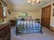 Cozy bedroom with sloped ceilings, patterned bedding, a dark wood dresser, and a view from the bed at 6605 Donnelly Dr, Brownsburg, IN 46112